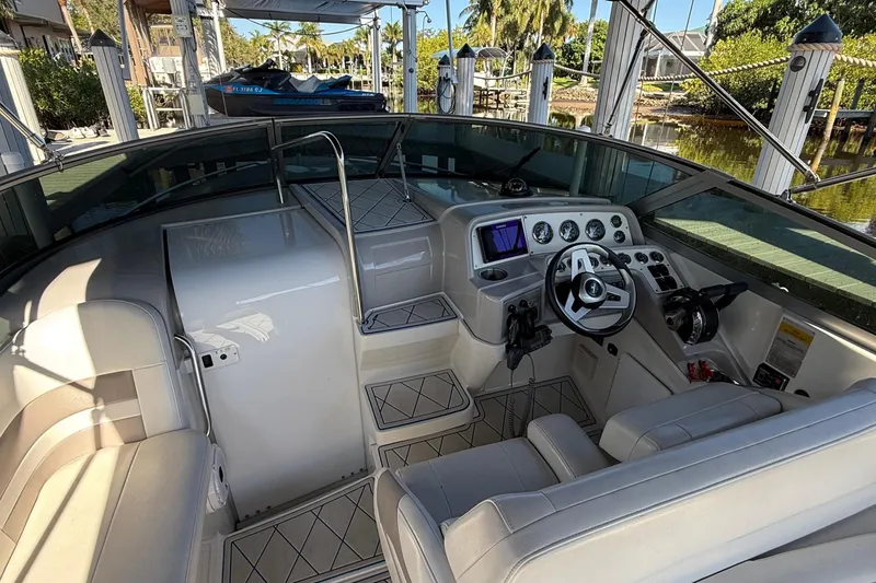 Slide: The Image of 1999 Formula 280 Sun Sport boat interior with white seating and modern dashboard. - 8