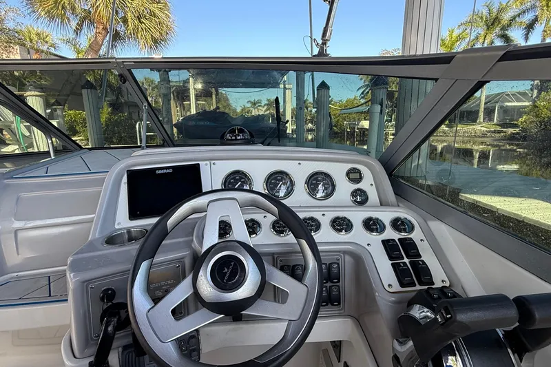 Slide: The Image of 1999 Formula 280 Sun Sport boat interior with steering wheel and seating. - 9