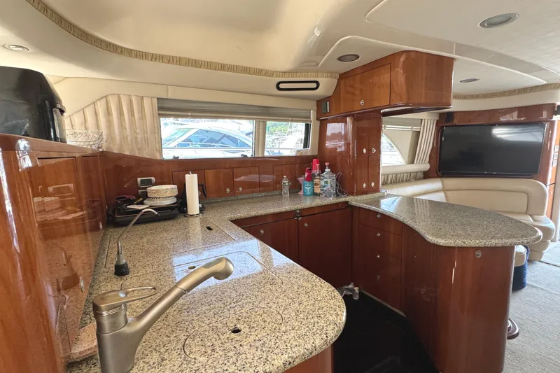Slide: The Image of Luxurious 2004 Sea Ray 560 Sedan Bridge yacht interior with modern kitchen and elegant wood finishes. - 11