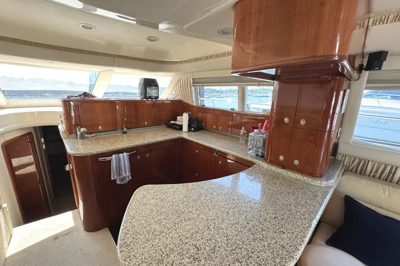 Slide: The Image of Luxurious kitchen interior of 2004 Sea Ray 560 Sedan Bridge yacht with wood cabinetry. - 13