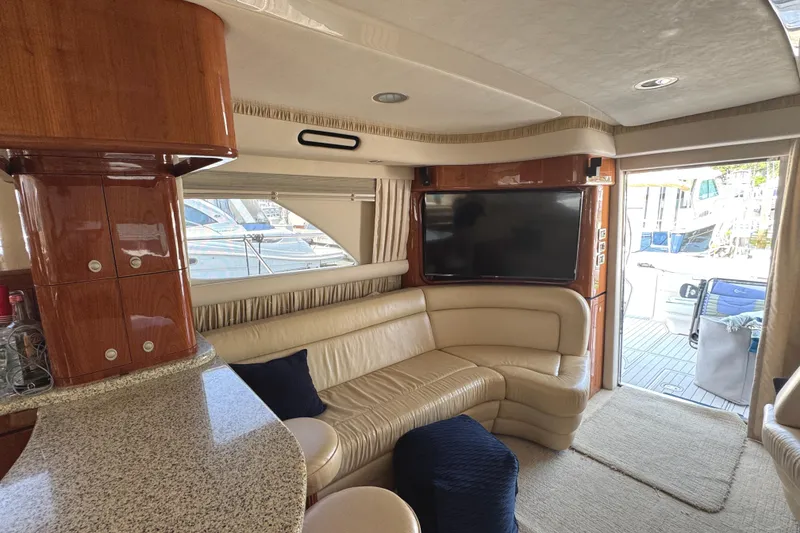 Slide: The Image of Luxurious interior of 2004 Sea Ray 560 Sedan Bridge yacht with leather seating and TV. - 15