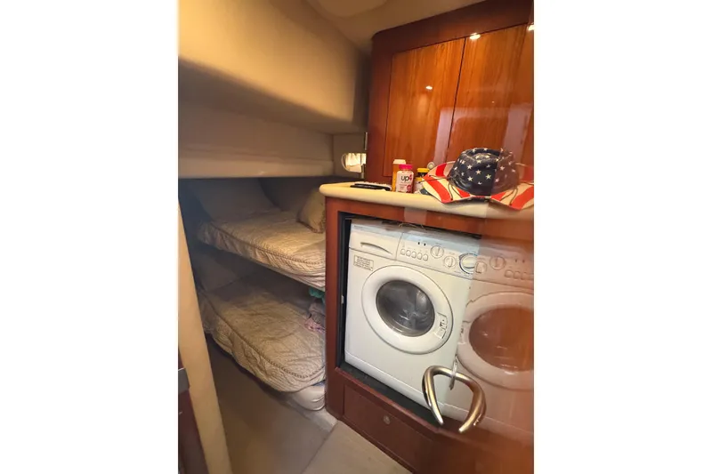Slide: The Image of Interior of 2004 Sea Ray 560 Sedan Bridge with bunk beds and washing machine. - 20