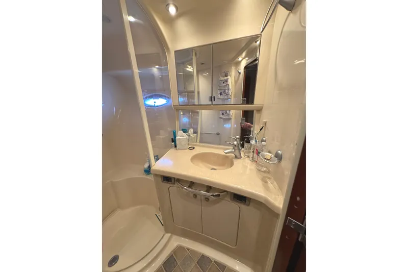 Slide: The Image of Luxurious bathroom in 2004 Sea Ray 560 Sedan Bridge yacht, featuring elegant fixtures and ample storage. - 23