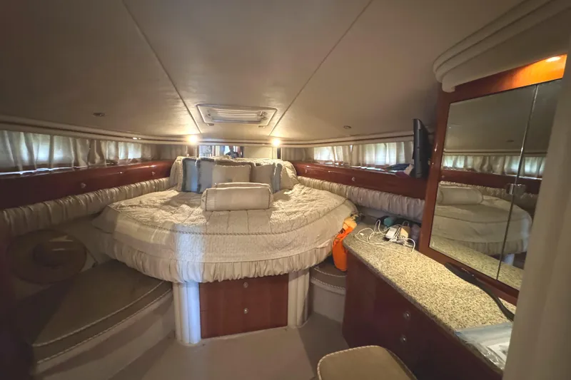 Slide: The Image of Luxurious 2004 Sea Ray 560 Sedan Bridge yacht bedroom with elegant decor and cozy bedding. - 24