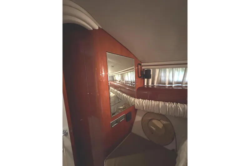 Slide: The Image of Interior of 2004 Sea Ray 560 Sedan Bridge with wood paneling and mirror. - 25