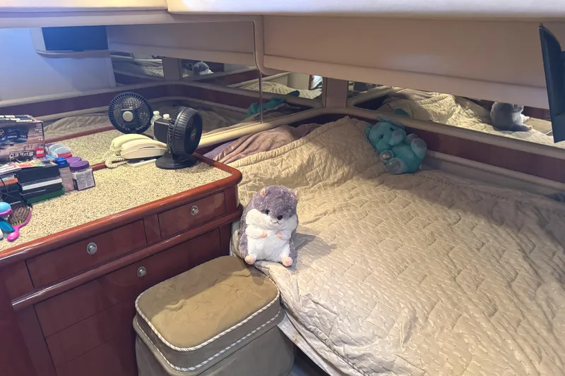 Slide: The Image of Cozy cabin interior of 2004 Sea Ray 560 Sedan Bridge with plush toys and personal items. - 31