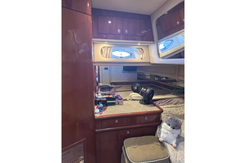 Slide: The Image of Luxurious 2004 Sea Ray 560 Sedan Bridge cabin interior with wood cabinetry and plush decor. - 32