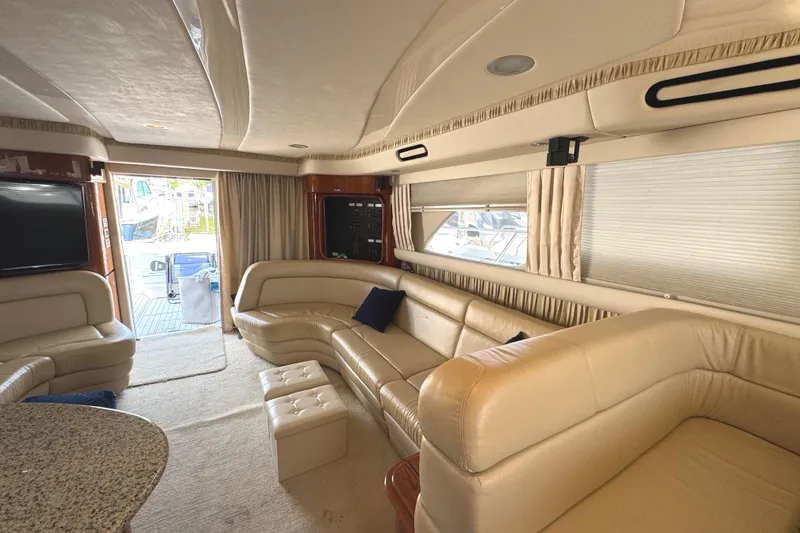 Slide: The Image of Luxurious interior of 2004 Sea Ray 560 Sedan Bridge yacht with beige leather seating. - 34