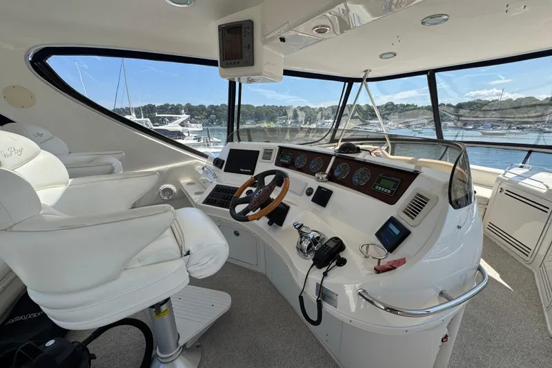 Slide: The Image of 2004 Sea Ray 560 Sedan Bridge helm with luxurious seating and advanced navigation controls. - 36