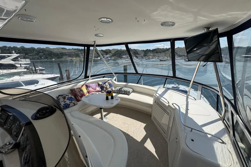 Slide: The Image of Luxurious 2004 Sea Ray 560 Sedan Bridge interior with scenic marina view. - 37