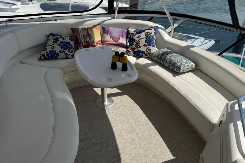 Slide: The Image of Luxurious 2004 Sea Ray 560 Sedan Bridge yacht interior with plush seating and decorative pillows. - 38