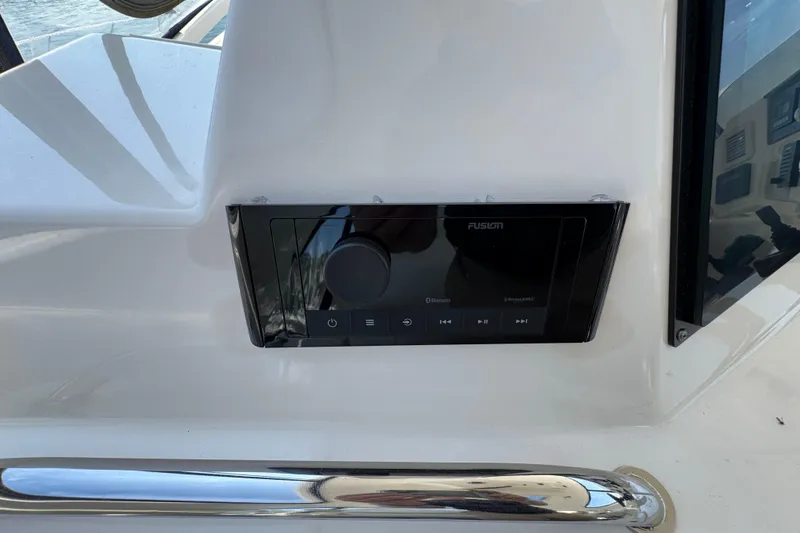 Slide: The Image of Control panel on 2004 Sea Ray 560 Sedan Bridge yacht, featuring Fusion audio system. - 42