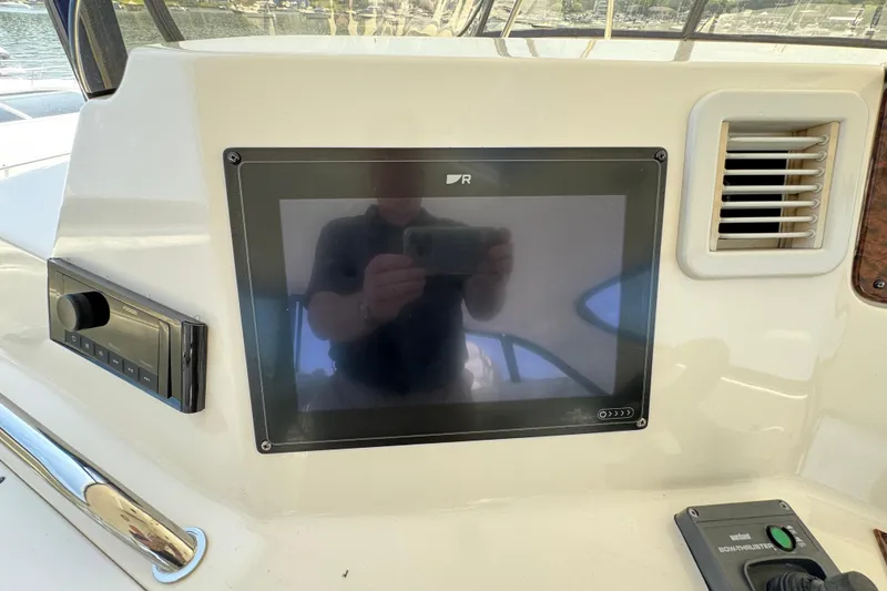 Slide: The Image of Control panel on a 2004 Sea Ray 560 Sedan Bridge yacht, featuring a touchscreen display. - 43
