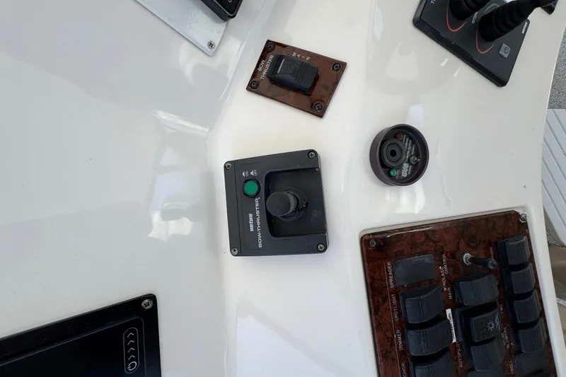 Slide: The Image of Control panel of a 2004 Sea Ray 560 Sedan Bridge yacht with various switches and dials. - 45