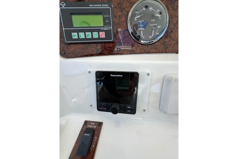 Slide: The Image of Control panel of a 2004 Sea Ray 560 Sedan Bridge yacht with navigation and engine displays. - 47