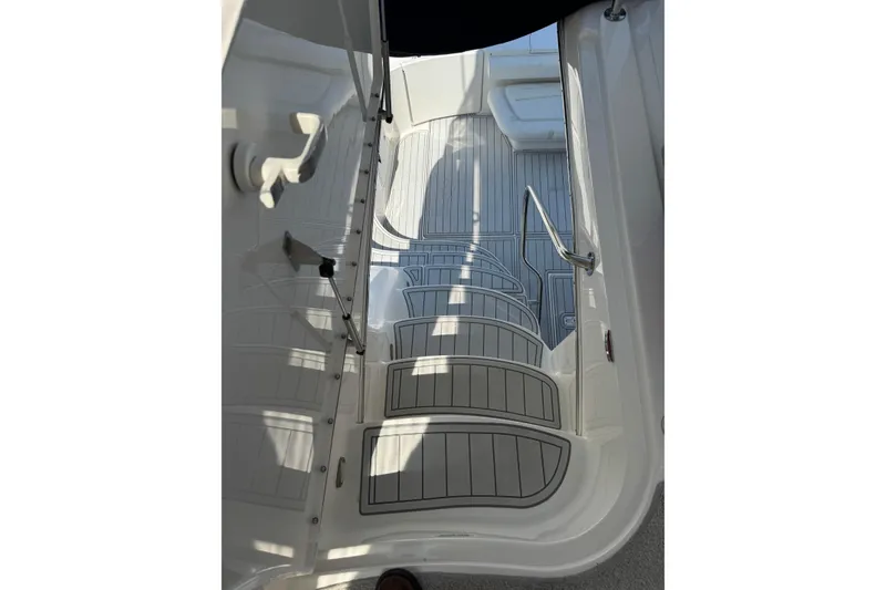 Slide: The Image of 2004 Sea Ray 560 Sedan Bridge boat deck with sleek, modern design and stainless steel railing. - 53