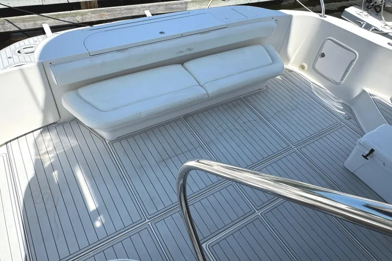 Slide: The Image of 2004 Sea Ray 560 Sedan Bridge yacht deck with white seating and sleek flooring. - 55