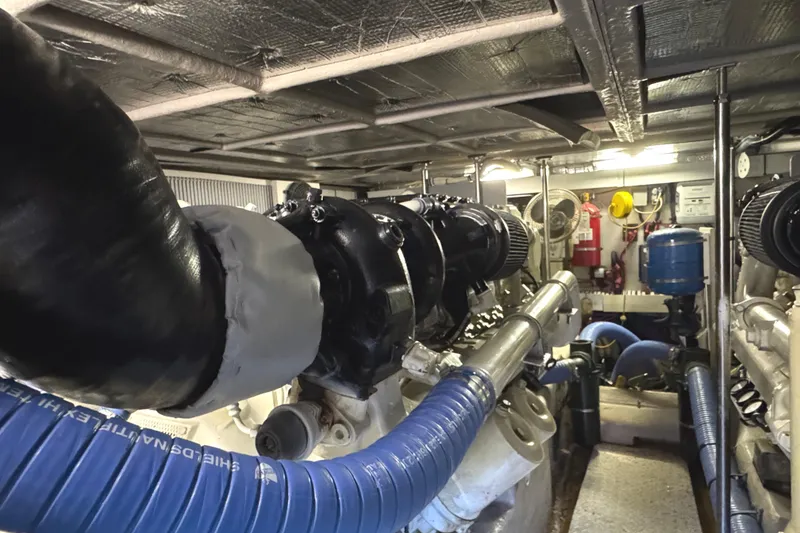 Slide: The Image of Engine room of 2004 Sea Ray 560 Sedan Bridge with visible machinery and piping. - 57