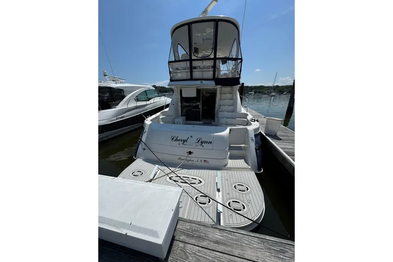 Slide: The Image of 2004 Sea Ray 560 Sedan Bridge yacht docked at marina, rear view. - 6