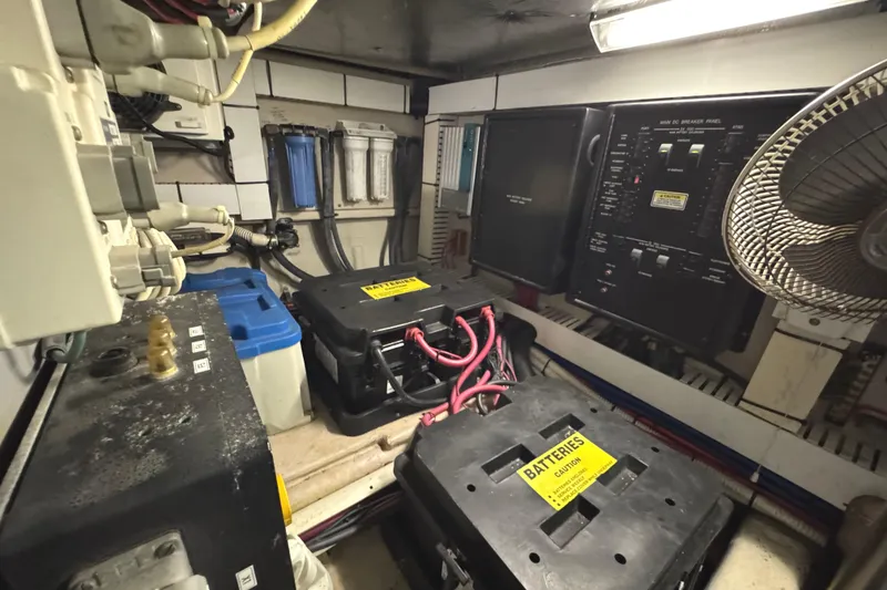 Slide: The Image of Engine room of 2004 Sea Ray 560 Sedan Bridge with batteries and control panel. - 63
