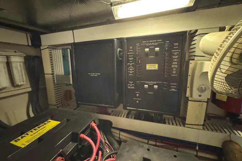 Slide: The Image of Electrical panel and battery compartment in 2004 Sea Ray 560 Sedan Bridge yacht. - 64