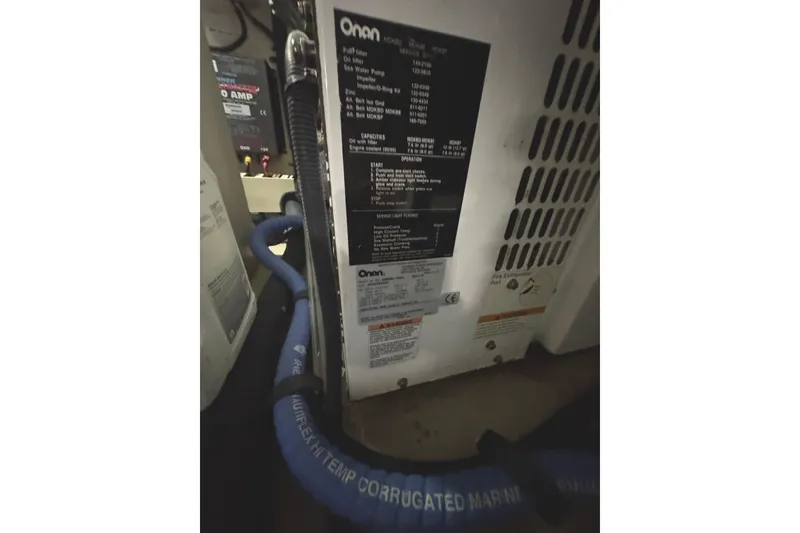 Slide: The Image of Engine room of 2004 Sea Ray 560 Sedan Bridge with Onan generator and marine hose. - 69