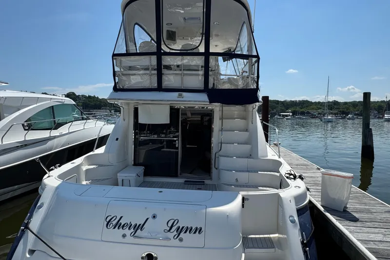 Slide: The Image of 2004 Sea Ray 560 Sedan Bridge yacht docked at marina, rear view. - 7