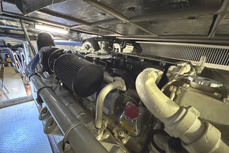 Slide: The Image of Engine room of 2004 Sea Ray 560 Sedan Bridge yacht, showcasing detailed machinery components. - 71