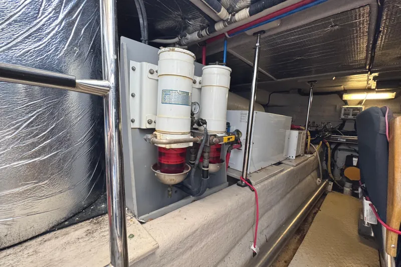 Slide: The Image of Engine room of 2004 Sea Ray 560 Sedan Bridge with fuel filters and equipment. - 73