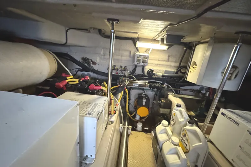 Slide: The Image of Engine room of a 2004 Sea Ray 560 Sedan Bridge with various equipment and components. - 75