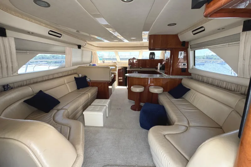 Slide: The Image of Luxurious interior of 2004 Sea Ray 560 Sedan Bridge yacht with leather seating and wooden accents. - 8