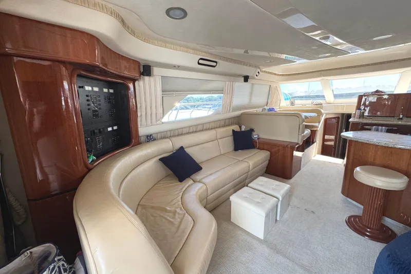 Slide: The Image of Luxurious interior of 2004 Sea Ray 560 Sedan Bridge yacht with leather seating and wood accents. - 9