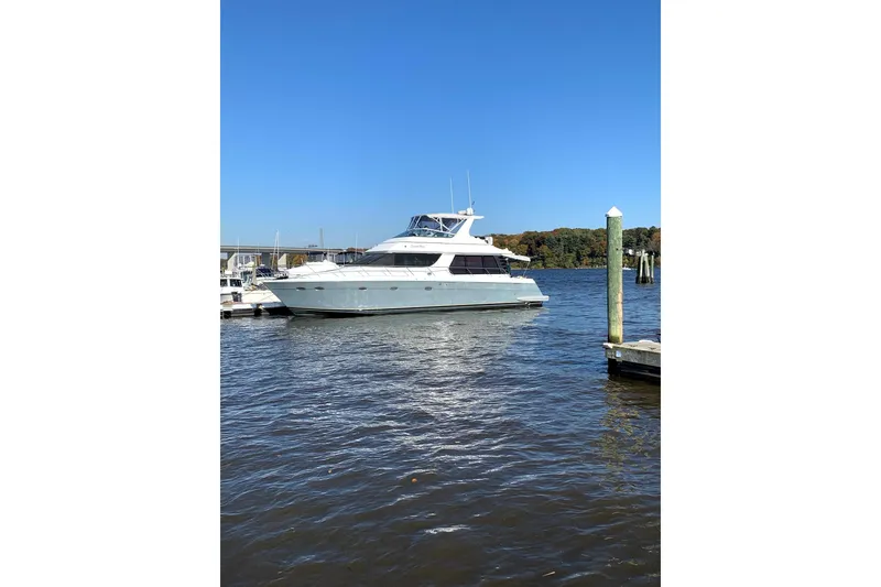 The Image of 1999 Carver 530 Voyager Pilothouse yacht docked on a sunny day. - 0
