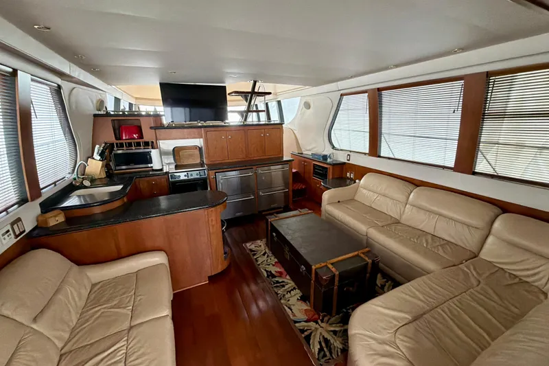 Slide: The Image of Luxurious interior of 1999 Carver 530 Voyager Pilothouse yacht with leather seating and modern kitchen. - 11