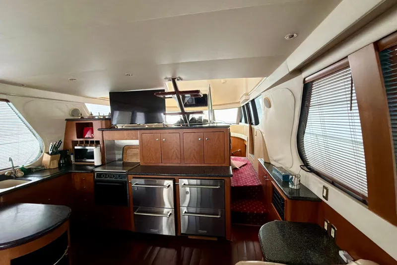 Slide: The Image of Interior of 1999 Carver 530 Voyager Pilothouse with modern kitchen and cozy seating area. - 16