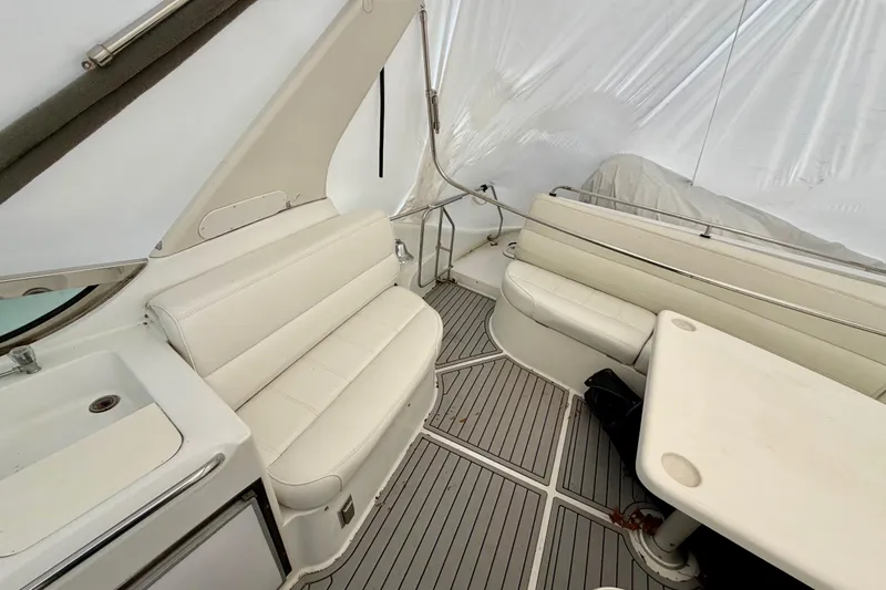 Slide: The Image of 1999 Carver 530 Voyager Pilothouse interior with white seating and table. - 37
