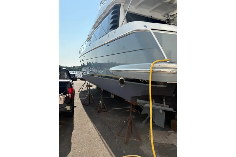 Slide: The Image of 1999 Carver 530 Voyager Pilothouse yacht on stands, side view with yellow hose. - 4