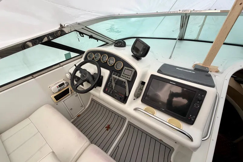 Slide: The Image of 1999 Carver 530 Voyager Pilothouse helm with navigation equipment and steering wheel. - 40