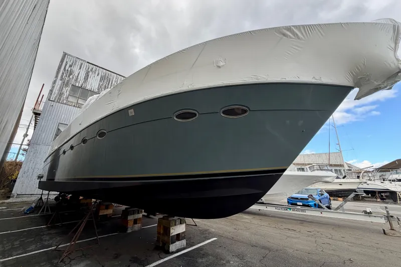 Slide: The Image of 1999 Carver 530 Voyager Pilothouse yacht in dry dock, covered for protection. - 7