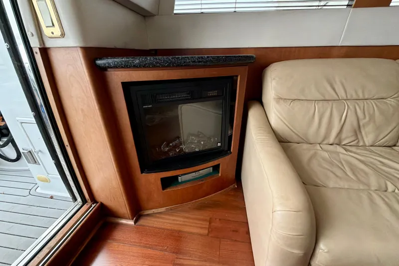 Slide: The Image of Luxurious interior of 1999 Carver 530 Voyager Pilothouse with fireplace and leather seating. - 15