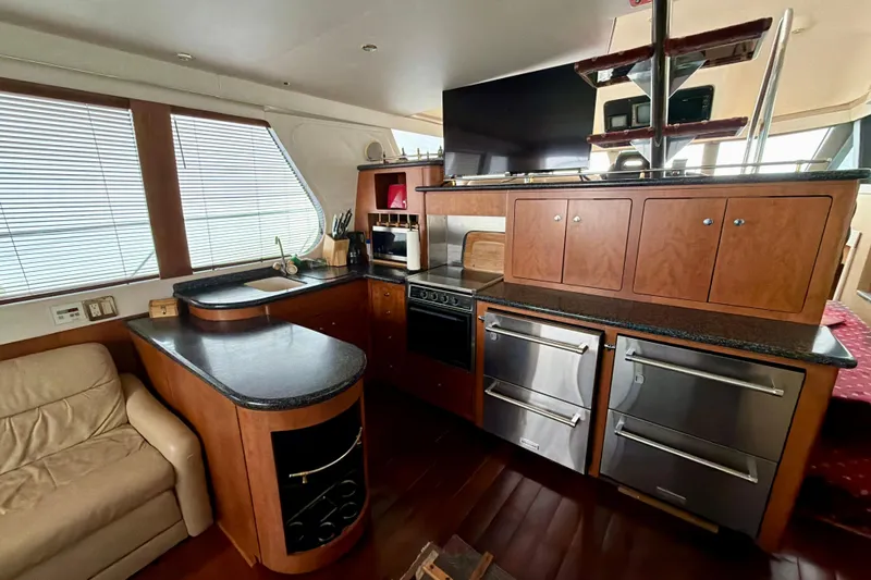 Slide: The Image of Interior of 1999 Carver 530 Voyager Pilothouse yacht with modern kitchen amenities. - 17
