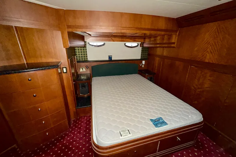 Slide: The Image of Luxurious bedroom interior of 1999 Carver 530 Voyager Pilothouse yacht with wood finish. - 26