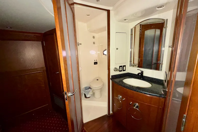 Slide: The Image of 1999 Carver 530 Voyager Pilothouse bathroom with wood cabinetry and modern fixtures. - 29