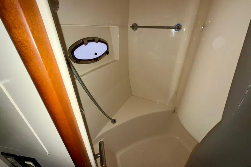 Slide: The Image of Shower area in 1999 Carver 530 Voyager Pilothouse with porthole and wooden trim. - 31