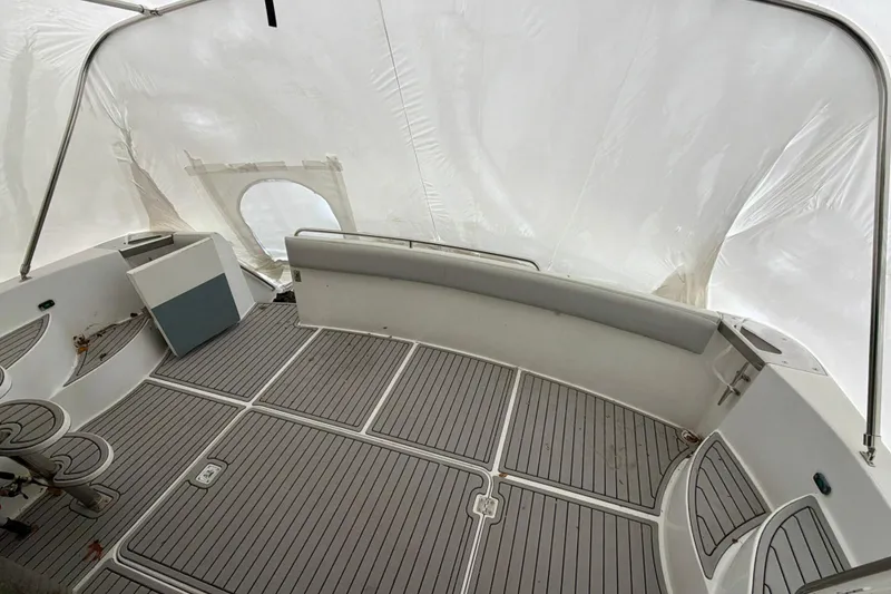 Slide: The Image of 1999 Carver 530 Voyager Pilothouse interior with covered deck and seating area. - 32