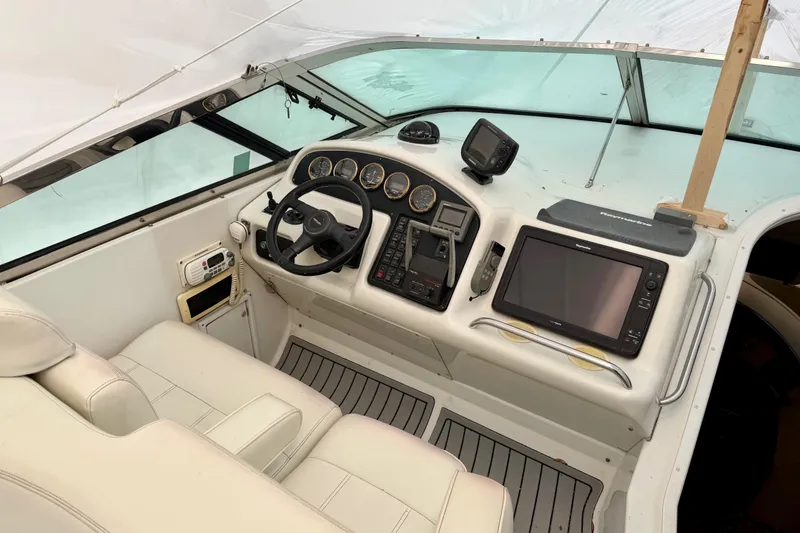 Slide: The Image of 1999 Carver 530 Voyager Pilothouse helm with navigation equipment and steering wheel. - 34