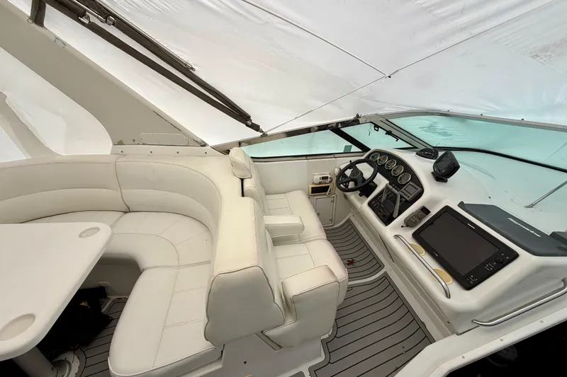 Slide: The Image of 1999 Carver 530 Voyager Pilothouse interior with white seating and control panel. - 35