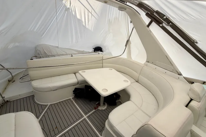 Slide: The Image of 1999 Carver 530 Voyager Pilothouse interior with white seating and table. - 36