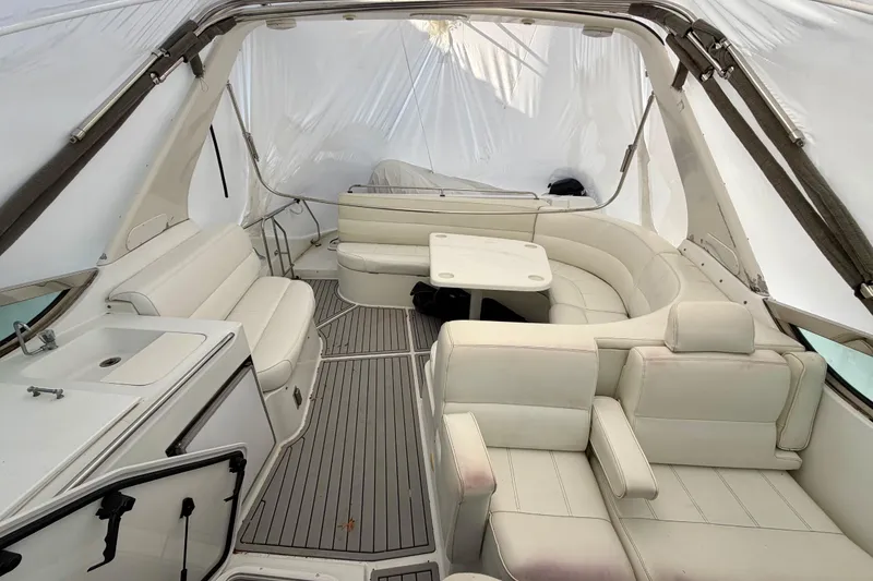 Slide: The Image of 1999 Carver 530 Voyager Pilothouse interior with white seating and table. - 38