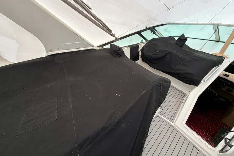 Slide: The Image of 1999 Carver 530 Voyager Pilothouse with covered seating area and helm, showcasing sleek design. - 42